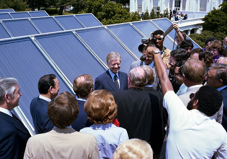 A photo of Jimmy Carter proudly showing solar panels at the White House in 1979. 